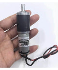 Planetary Gearbox Gear Drive Kit For Electronic Starter, 25mm Shaft in hand, DC 6V-12V Motor with wires showing, Compact Durable Metal Housing