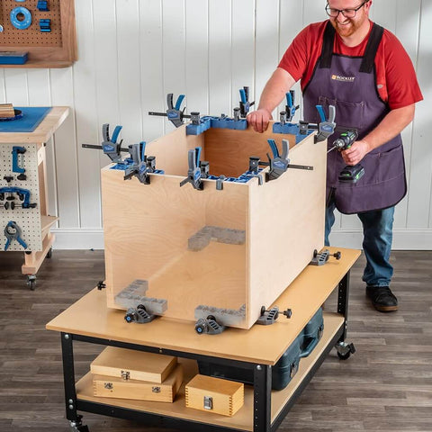 Clamp It Corner Woodworking Jig For 90 Degree Right Angle Cabinet Assembly in use on wooden cabinet, hands-free positioning.
