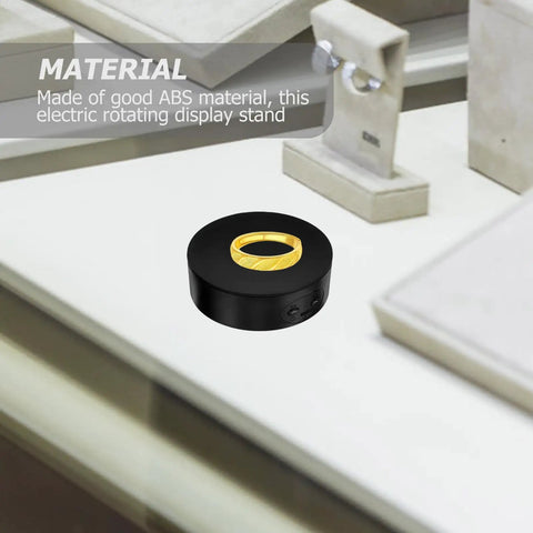 Electric Rotating Jewelry Display Stand, 360 Degree Turntable For Showcasing Accessories Or Crafts on a counter.