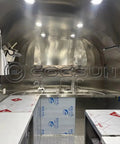 Interior view of Ready To Rock 10ft Mobile Food Trailer Built On Galvanized Steel Frame with stainless prep counter and dual sink.