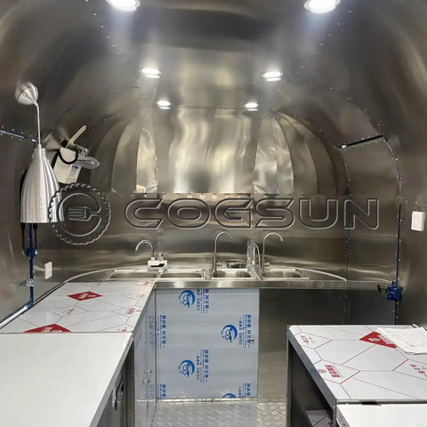 Interior view of Ready To Rock 10ft Mobile Food Trailer Built On Galvanized Steel Frame with stainless prep counter and dual sink.