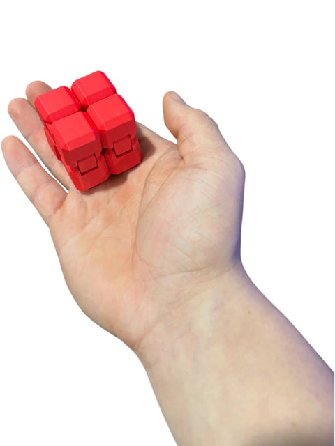 Person holding a red 3D Printed Infinity Cube Stress Relief Toy For Focus And Fun A Pocket Sized Red Fidget With Smooth Folding Action.