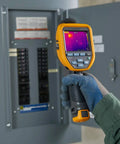 Person using Pro Grade Thermal Imager With IR Fusion, 30 Hz GT1 in front of electrical panel for quick asset diagnostics.