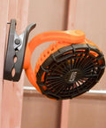 Cordless Rechargeable Fan With USB-C Charging Cord And Multiple Mounting Options For The Jobsite, clipped on wood surface