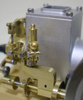 Close-up of brass and silver components of the six cubic centimeter hit and miss gasoline engine for engineering demonstrations.