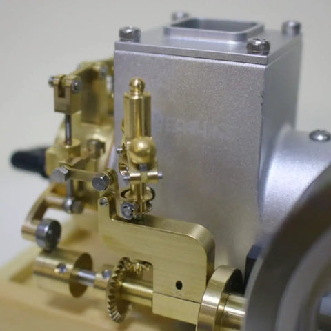 Close-up of brass and silver components of the six cubic centimeter hit and miss gasoline engine for engineering demonstrations.