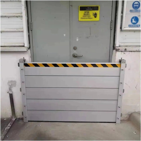 Heavy Duty Aluminum Flood Shields For Doors And Warehouse Openings, layered gray panels at entrance blocking potential water surge.