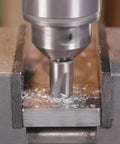 3/8 Inch 90 Degree High Speed Steel Chatterless Countersink Featuring Six Precision Flutes in use on steel surface with shavings.