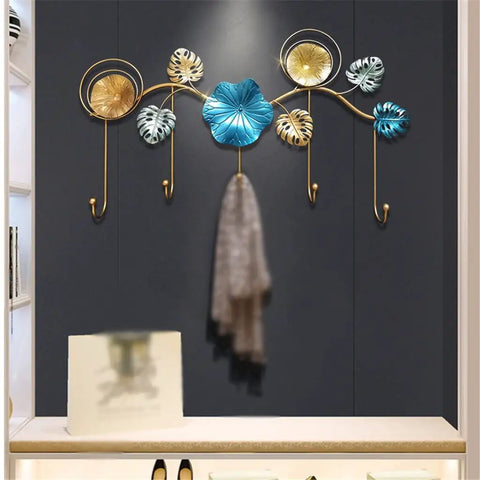 Rock Tight Wrought Iron Wall Hook For Sleek Nordic Style And Snug Door Storage That Locks In Keys Bags And Jackets Without A Sweat While Serving Heavy Duty Swag On Your Front Porch, featuring gold and blue decorative leaves.
