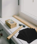 Awesome 9 Sheet Wet Dry Sandpaper Square Assortment Set With 60 To 320 Grit Levels on a windowsill with a hammer and wood.