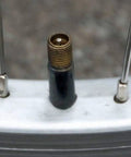 Schrader valve on a bicycle wheel, part of Universal 16 Inch Bicycle Inner Tube Fits 16 By 1.75 To 2.25 Inches With Schrader Valve Durable Mold Cured