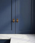 Top Notch Heavy Duty Solid Zinc Cabinet Knobs With Vintage Oval Beaded Back Plates Antique Brass Finish six pack on navy cabinet doors.