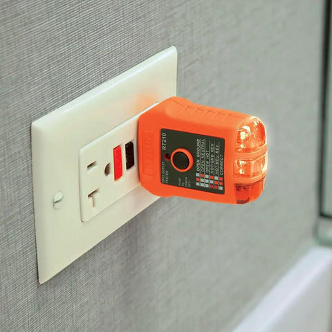 Electrical Test Kit With GFCI Outlet Tester And AC DC Voltage Tester plugged into wall outlet