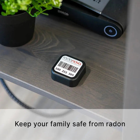 Radtrak³ Home Radon Detector For Long Term Testing 90 Days To 1 Year, Easy To Use Setup on a shelf next to a plant