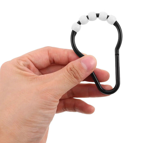 Hand holding a black Beaded Glide Shower Curtain Ring showing its bead design; part of a 20 pack for bathroom rods.