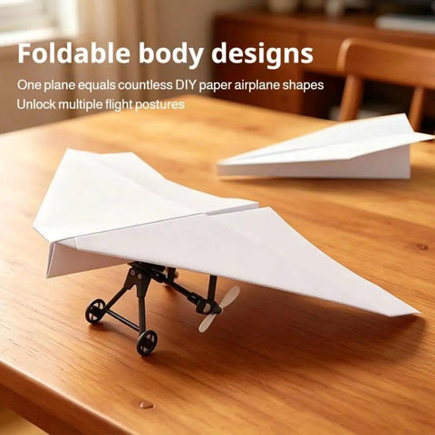 Foldable Electric RC Paper Airplane Kit With Gyro Stabilizer Dual Propellers on wooden table, DIY lightweight flyer.