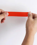 Top Notch Pipe Repair Tape That Seals Waterproof Leaks In A Flash held in hands showing red self-fusing adhesive tape.