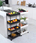Two kitchen trolleys with fruits and vegetables beside a modern kitchen island.