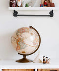 Decorative shelf supported by six pack half inch by fourteen inch black metal pipe pre cut for industrial shelving and DIY decor.