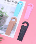 Set Of 6 Thermoplastic Rubber Door Stopper Wedges For Anti Slip Protection And Finger Pinch Prevention shown on pink background
