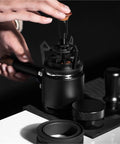 Close-up of Rotary Espresso WDT Tool Set With Precision Dosing Funnel And Upright Stand demonstrating clump clearing action.