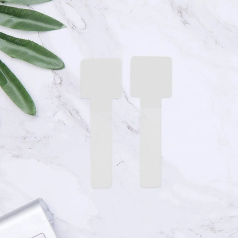 Self Adhesive Cable Straps Keep Your Desk Clean And Tangle Free Bundle Wires Fast With Reusable Hook And Loop Design on a marble surface.