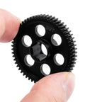 Hand holding Beefy Steel Main Gear 0.5M 59T RC Spur Gear for Arrma 1 By 18 Granite Grom Typhon upgrade, close-up view.