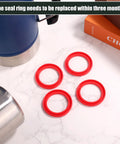 Top-view of four red silicone O-ring gaskets for Stanley Classic Thermos lid.