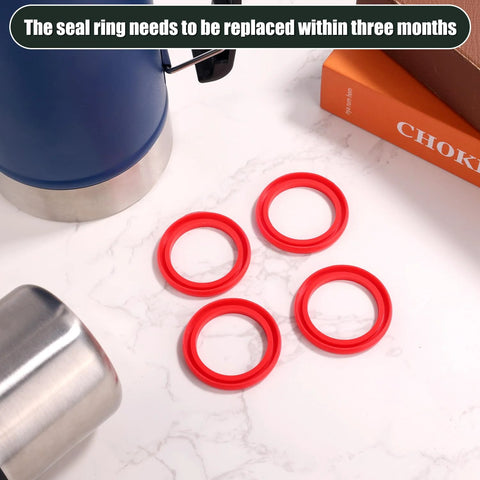 Top-view of four red silicone O-ring gaskets for Stanley Classic Thermos lid.