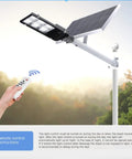 Rugged Outdoor Solar Wall Light With Super Bright Waterproof Security Flood Light And Remote Control showcasing remote control and solar panel.