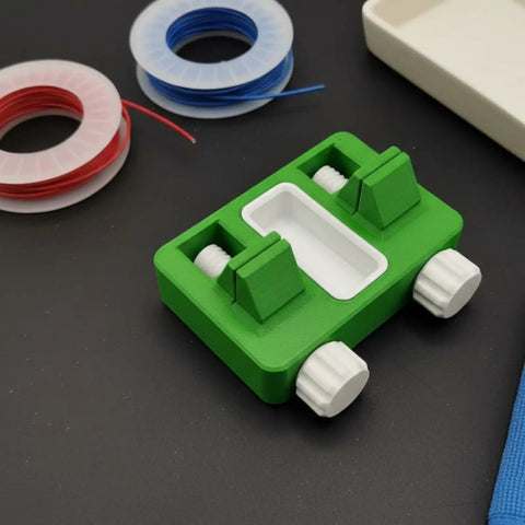 Fixture Wire Clamp Soldering Jig Adjustable Holder Precision Clamping Tool for electronics repair and workbench additive manufacturing utility, green and white base, next to spools of wire