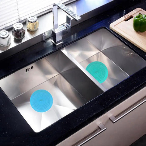 Slick Silicone Tub Stopper Two Pack, 5 Inch Flat Suction Bath Plug With Heavy Grip in stainless steel sink, blue design.