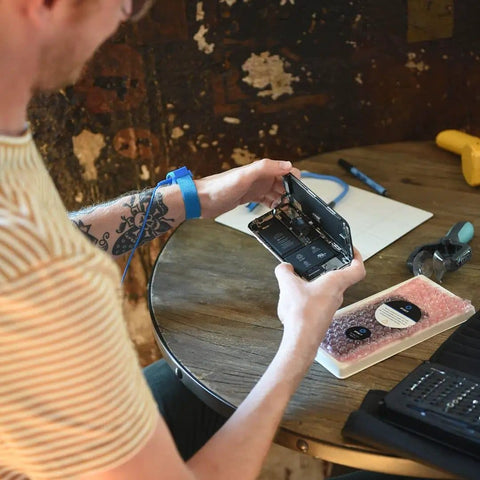 Person using Anti Static Wrist Strap For Electronics Repair And ESD Grounding Wristband With Adjustable XL Size, blue color.