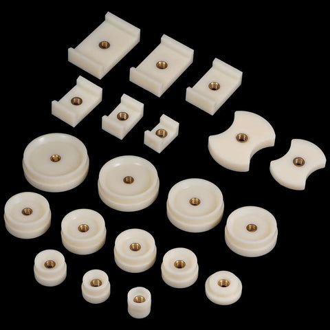 20 Piece Watch Case Press Die Kit With Nylon Fitting Dies For Table Model Capping Machine Includes Round Square And Shield Dies For Back Case Repair DIY Friendly White ABS Plastic. Variety of white ABS plastic dies for watch repairs on black background.