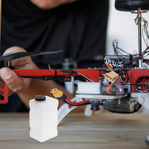 Clear 120CC RC Plane Fuel Tank Set With Metal Tubing alongside RC aircraft, demonstrating compact fit and easy monitoring.