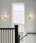 Marble Wall Sconce with Frosted Glass Globe and G4 LED (Rectangular) installed on wall near window in a stairway.