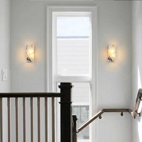Marble Wall Sconce with Frosted Glass Globe and G4 LED (Rectangular) installed on wall near window in a stairway.
