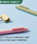 Close-up of pink and green pens with soft touch grip on blue surface next to metal clip. Pure Gel Pens 20 Color Ink Set With 0.7 mm Medium Point Soft Touch Grip For Journaling Note Taking Doodling And Creative Projects Vibrant Assorted Ink