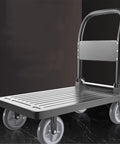 Heavy Duty Foldable Platform Trolley With Smooth As Butter Eight Inch Rubber Wheels And Trustworthy Parking Brake For No Sweat Setup Beast Mode Sack Truck Hauling, black platform with handle and rubber wheels.