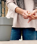 Woman using Epoxy Repair Putty For Quick Fixes Handy Two Part Moldable Adhesive That Bonds To Damp Surfaces And Cures Underwater For Small Emergency Repairs 2 Oz Stick 1 Pack to repair a broken flower pot.