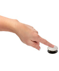 Hand pressing Push And Seal Replacement Stopper 972098J Brushed Nickel for standard sink drains, shown on finger tip