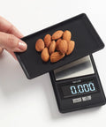 Ultra Portable High Precision Digital Portioning Scale With Cover For Accurate Weighing In Ounces And Grams 16 Oz 500 G Black With Tare Function For Quick Meal Prep On The Go with almonds on the weighing tray