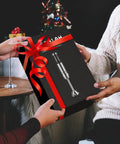 Two hands exchanging a gift box containing Heavy Duty 1000W Immersion Blender With 25 Adjustable Speed Settings And Tough Copper Brushless Motor.