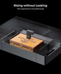 xTool P2 riser base for CO2 laser cutter; orange workbed inside a transparent enclosure.