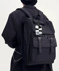 Compact Black And White Piano Grid Print Luggage Tags With Personalized Name Tags For Slick Travel Setup visible on black backpack.