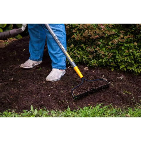 Person using Steel 16 Tine Bow Rake With 57 Inch Hardwood Handle And Cushy Grip For Small Yard Work And Landscaping Projects Durable Garden Rake For Yard Cleanup Made In USA Everyday Use on mulch