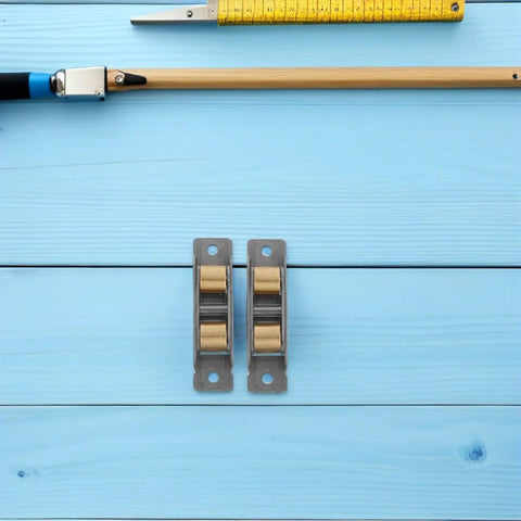 Dead Smooth Double Wheel Sliding Glass Door Rollers With Heavy Duty Steel Core Bearings on blue background with measuring tape.