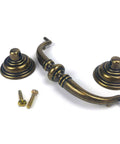 Antique Brass Drop Bail Pulls Set Of 4 With 4-1/4 Inch Center To Center Spacing displayed with screws, suitable for dressers and cupboards.
