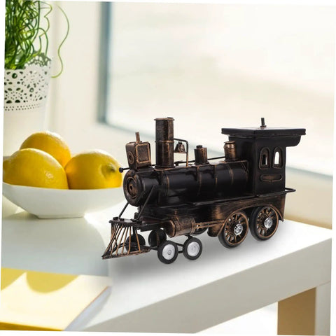 Locomotive Model Retro Steam Train Sculpture For Desktop Decoration on white table beside fruit bowl.