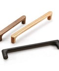 Three wooden cabinet handles in walnut, oak, and black finishes, showcasing minimalist design for kitchen doors and cabinets.